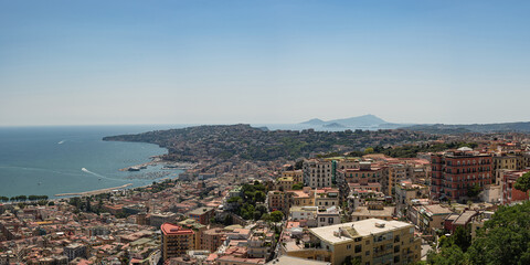 Obraz premium Amazing landscape on the terracotta roofs of Naples from the fortress of Sant Elmo. A charming observation deck with history. Panorama of the city.
