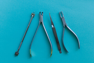 Dental tools for removing teeth on a blue background