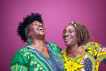 Studio shot of mature sisters laughing