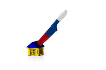 War in Ukraine. Small wooden house and knife isolated on white background. Copy space. Concept of an attack on Ukraine, dividing it into separate parts.