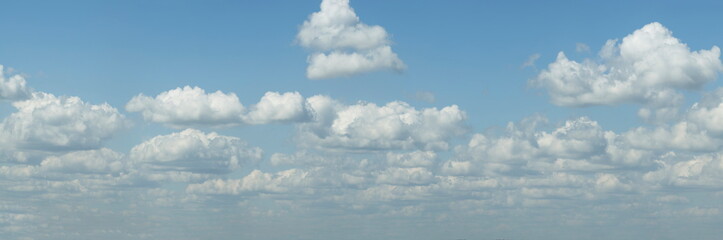 Russia. South of Western Siberia. Panorama of the daytime summer sky with cumulus clouds over the fields of Kuznetsk Alatau.