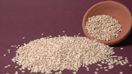  white sesame seeds, sesame seeds in a wooden spoon on an old rustic background close-up