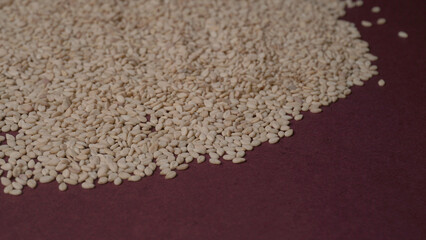  white sesame seeds, sesame seeds in a wooden spoon on an old rustic background close-up