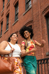 Two women in front of brick building