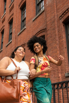 Two women in front of brick building