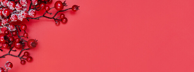 New Year banner with Christmas viburnum branches on red background. Copy space. Place for text....