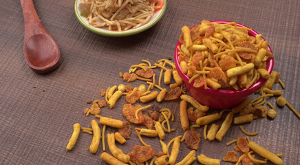 Indian Snacks, Traditional Indian deep fried salty dish called chivda or mixture or farsan made of gram flour and mixed with dry fruits and roasted nuts with salt, pepper, pulses, spice and green peas