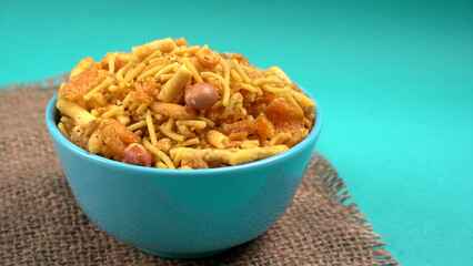 Indian Snacks, Traditional Indian deep fried salty dish called chivda or mixture or farsan made of gram flour and mixed with dry fruits and roasted nuts with salt, pepper, pulses, spice and green peas