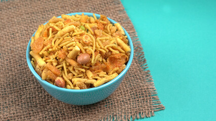 Indian Snacks, Traditional Indian deep fried salty dish called chivda or mixture or farsan made of gram flour and mixed with dry fruits and roasted nuts with salt, pepper, pulses, spice and green peas
