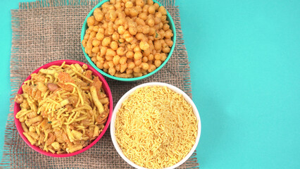 Indian Snacks, Traditional Indian deep fried salty dish called chivda or mixture or farsan made of gram flour and mixed with dry fruits and roasted nuts with salt, pepper, pulses, spice and green peas