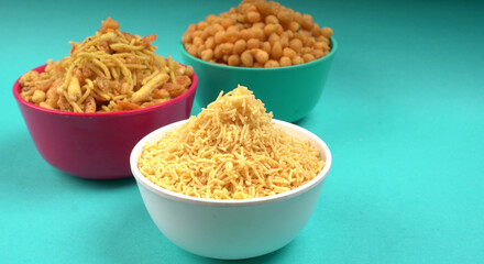 Indian Snacks, Traditional Indian deep fried salty dish called chivda or mixture or farsan made of gram flour and mixed with dry fruits and roasted nuts with salt, pepper, pulses, spice and green peas