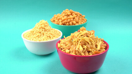 Indian Snacks, Traditional Indian deep fried salty dish called chivda or mixture or farsan made of gram flour and mixed with dry fruits and roasted nuts with salt, pepper, pulses, spice and green peas