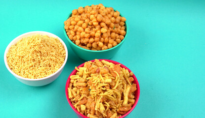 Indian Snacks, Traditional Indian deep fried salty dish called chivda or mixture or farsan made of gram flour and mixed with dry fruits and roasted nuts with salt, pepper, pulses, spice and green peas