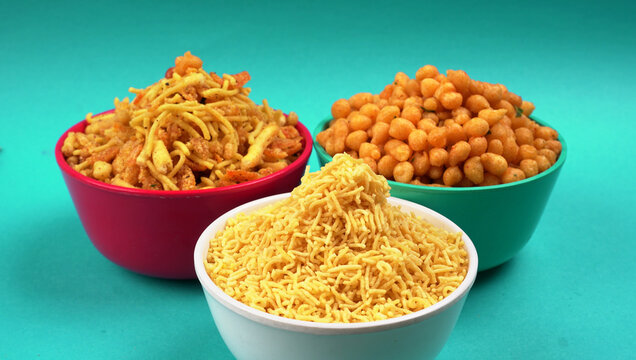 Indian Snacks, Traditional Indian deep fried salty dish called chivda or mixture or farsan made of gram flour and mixed with dry fruits and roasted nuts with salt, pepper, pulses, spice and green peas
