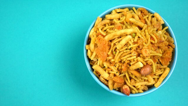 Indian Snacks, Traditional Indian deep fried salty dish called chivda or mixture or farsan made of gram flour and mixed with dry fruits and roasted nuts with salt, pepper, pulses, spice and green peas