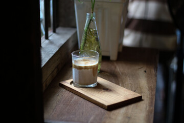 dirty coffee iced latte freeze milk pour espresso shot in a cup of coffee on scale measurement wooden bar table cafe in thailand asia by barista workout