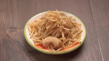 Indian Snacks, Traditional Indian deep fried salty dish called chivda or mixture or farsan made of gram flour and mixed with dry fruits and roasted nuts with salt, pepper, pulses, spice and green peas