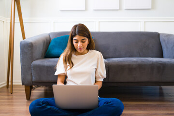 Young woman doing telecommute work and using the laptop