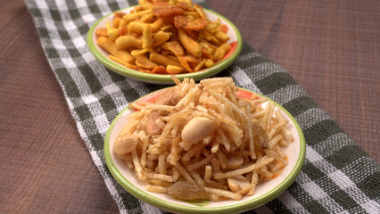 Indian Snacks, Traditional Indian deep fried salty dish called chivda or mixture or farsan made of gram flour and mixed with dry fruits and roasted nuts with salt, pepper, pulses, spice and green peas