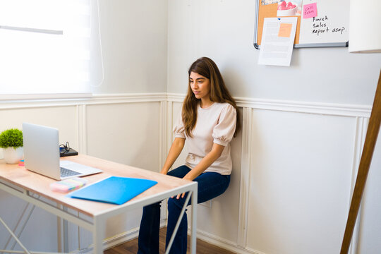 Active Woman Working Out At Her Desk While Working From Home