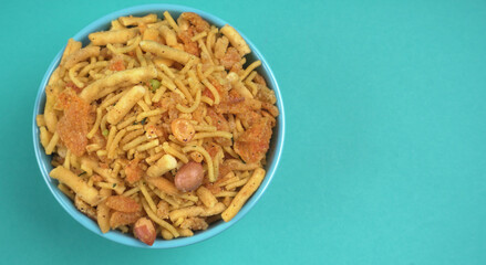 Indian Snacks, Traditional Indian deep fried salty dish called chivda or mixture or farsan made of gram flour and mixed with dry fruits and roasted nuts with salt, pepper, pulses, spice and green peas