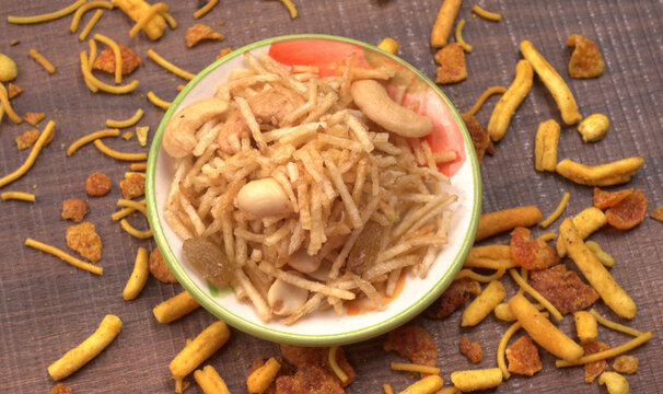 Indian Snacks, Traditional Indian deep fried salty dish called chivda or mixture or farsan made of gram flour and mixed with dry fruits and roasted nuts with salt, pepper, pulses, spice and green peas