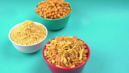 Indian Snacks, Traditional Indian deep fried salty dish called chivda or mixture or farsan made of gram flour and mixed with dry fruits and roasted nuts with salt, pepper, pulses, spice and green peas
