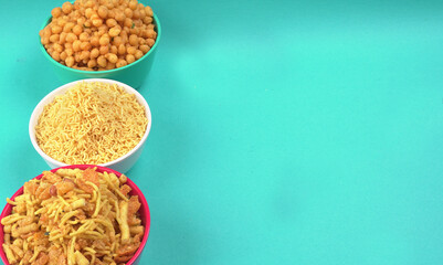 Indian Snacks, Traditional Indian deep fried salty dish called chivda or mixture or farsan made of gram flour and mixed with dry fruits and roasted nuts with salt, pepper, pulses, spice and green peas