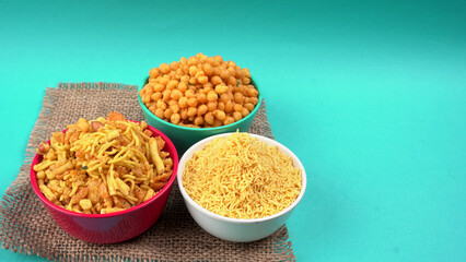 Indian Snacks, Traditional Indian deep fried salty dish called chivda or mixture or farsan made of gram flour and mixed with dry fruits and roasted nuts with salt, pepper, pulses, spice and green peas