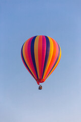 Colorful hot air balloon flying in the bright blue sky
