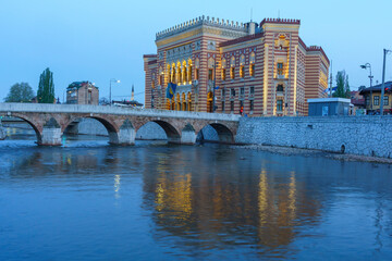 Sarajevo, Bosnia - May 2, 2022 - Library building was the City Hall before The War, and the Latin Bridge.
