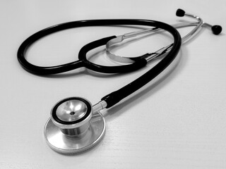 The stethoscope lies on a light table. medical tool. health care, diagnostics, listening to the...