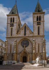 Sarajevo, Bosnia - May 2, 2022 - Sacred Heart Cathedral, with statue of Pope in front, who visited church after The War.