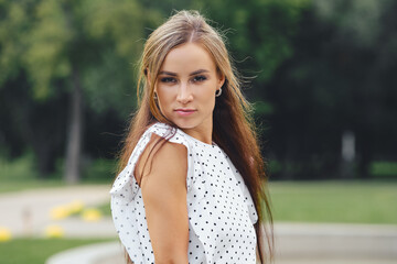 Pretty young woman with long hair looks suspicious