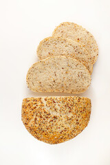 Wholegrain Organic Bread with crumbs isolated on white background. Sliced, cutted wheat bread. Top view. Food abstractions