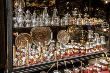 Fototapeta na wymiar Sarajevo, Bosnia - May 2, 2022 - Copper, silver and brass tableware for sale in shop.