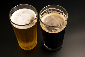 stout beer and lager beer on dark background
