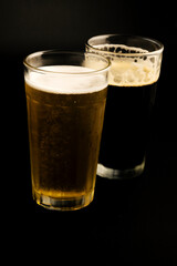 stout beer and lager beer on dark background