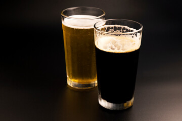 stout beer and lager beer on dark background