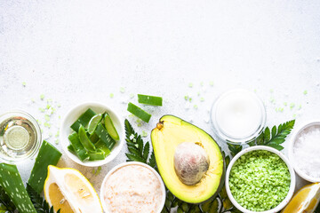 Natural cosmetics with ingredients, homemade cosmetic laboratory. Natural ingredients for healthy skin. Top view on white background.