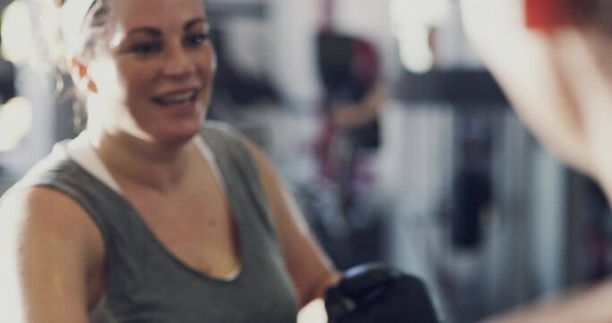 Boxer, athlete and fighter boxing, training and exercising in a gym, hitting a punching bag and working out for cardio and endurance. Chubby, plus size and overweight woman practicing for a fight
