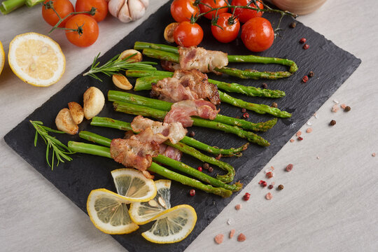 Asparagus baked with bacon and spices. healthy food. top view. homemade prosciutto wrapped asparagus with salt and pepper. ketogenic diet. diet menu. Top view, overhead, banner.