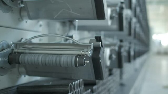 Operator works on polymer thread winding machine