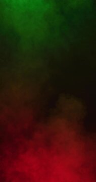Vertical video of white smoke with green and red light moving on black background