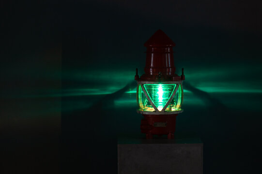 Green marine light glows in a dark, close up
