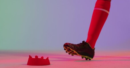 African american female rugby player with rugby ball over neon pink lighting - Powered by Adobe