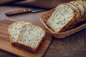 Whole grain bread slices on wooden board