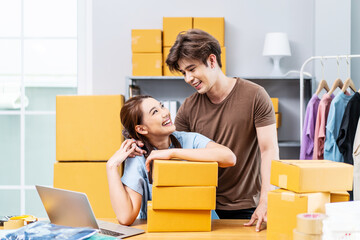 Young Asian couple business working in house office look like doing startup business and smiling happy and positive,Surprise of couple success on making big sale of his online store.