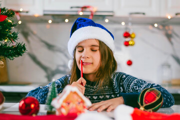 Cute girl kid write a letter to Santa. Christmas holidays concept.