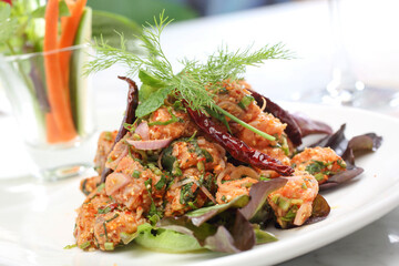 Spicy Fried Salmon Salad on a white plate